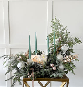 Transform your space into a festive haven with Christmas arrangement and taper candles