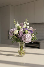 Load image into Gallery viewer, Bouquet of flowers in a clear vase on a kitchen counter
